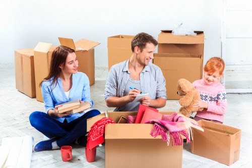 Professional movers handling furniture in a London apartment building