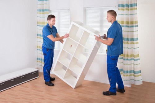 Professional movers loading furniture in a busy London area