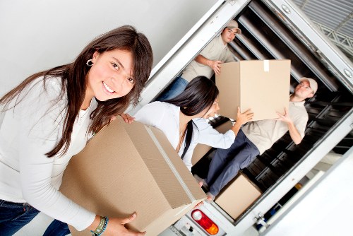 Packed boxes and furniture ready for a local removal van collection