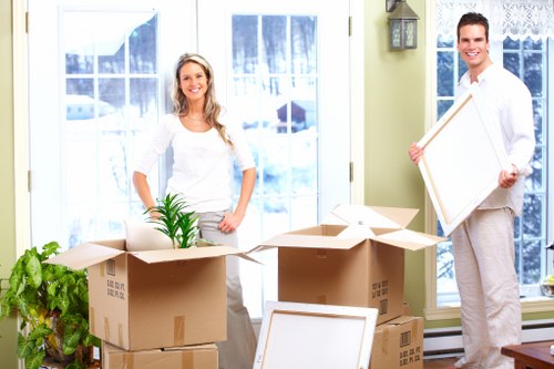 Mover wearing PPE while carrying furniture